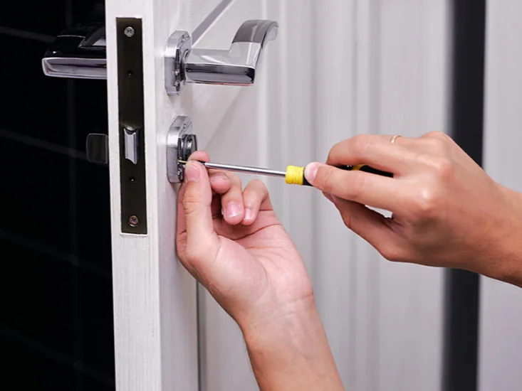 Locksmith fitting a lock cylinder during an emergency call-out