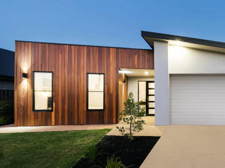 The exterior of a modern home with a clean rendered facade