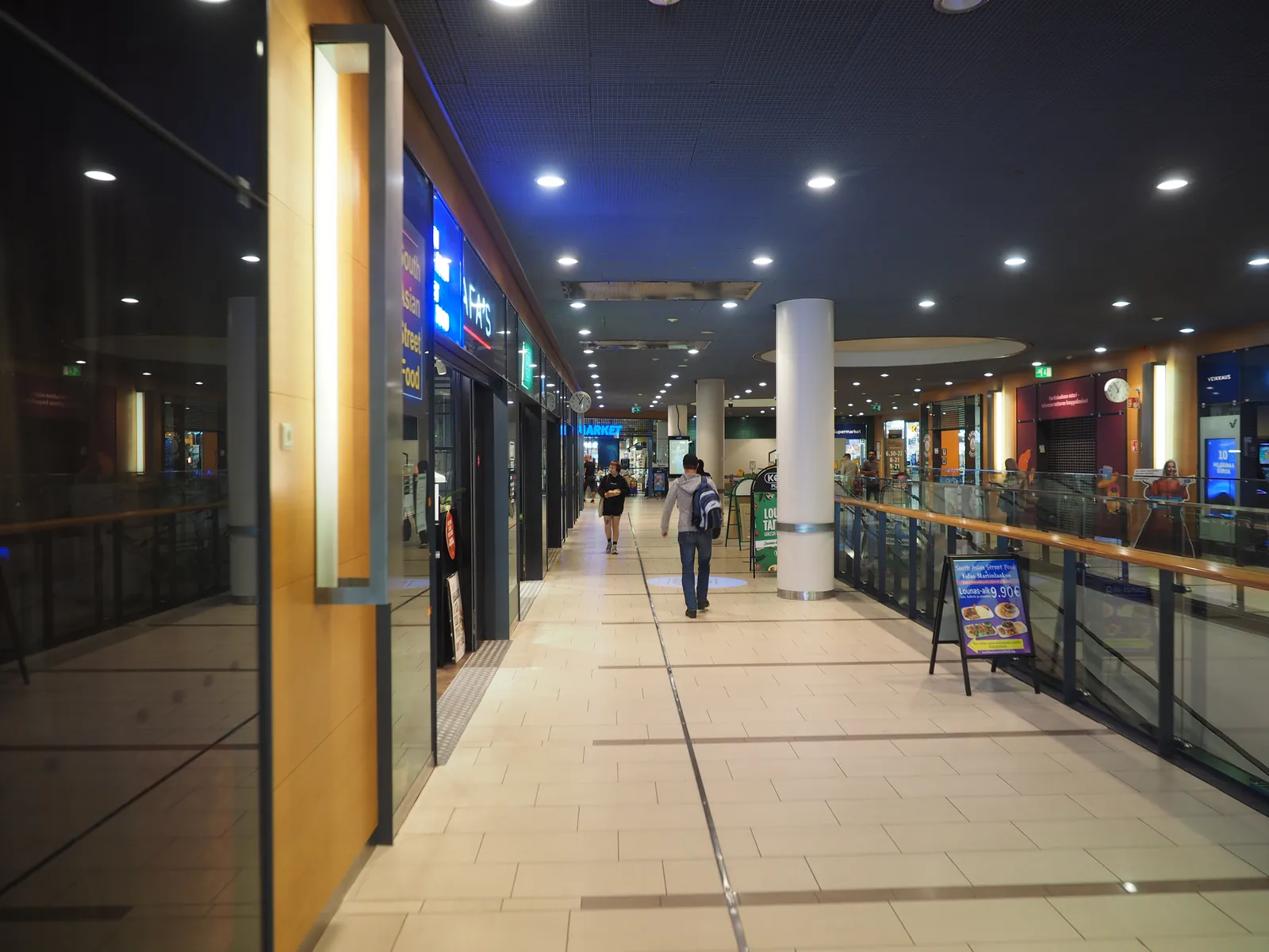 Shopping centre walkway with shopfronts on both sides