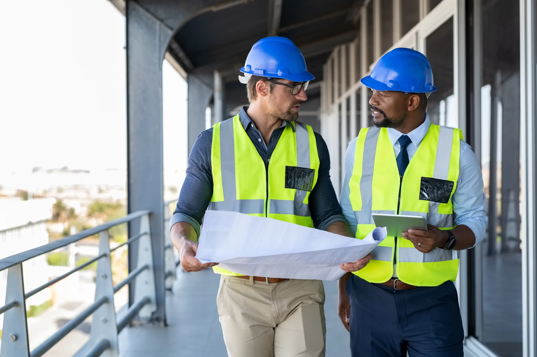 Two Leon Property Services site managers reviewing plans on a building site